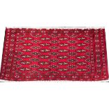 PERSIAN TURKMEN HANDWOVEN WOOL RUG, 3' 3" X 1' 7"having a red ground with three borders and rows