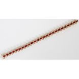 18K YELLOW GOLD FLEXIBLE BRACELET 25 OVAL-CUT RUBIES,APPROX. 4X5MM EACH, 150 ROUND FULL-CUT