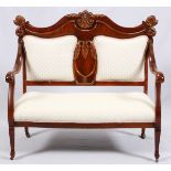 UPHOLSTERED MAHOGANY SETTEE, CIRCA 1900, H 44", W 47"Having a carved acanthus leaf motif at the