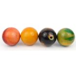 Four stained ivory snooker balls, each 5cm diameter : For Condition Reports please visit www.