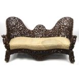 Black forest wooden serpentine fronted bench profusely carved with acorns and foliage carved bear