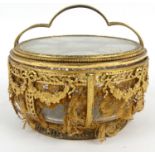 French pierced gilt metal and glass powder bowl with bow and swag design inset with lace, 15cm