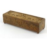 Black Forest wooden glove box carved with bears and lined with a  green buttoned silk interior, 35cm