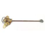 Horseracing interest shooting stick with a collection of members' badges attached including Epsom