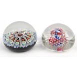 Two glass paperweights - one with colourful glass canes, the larger 7cm diameter :For Condition