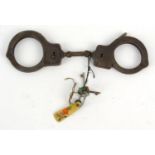 Set of American cast iron handcuffs, The Peerless Handcuff Co, Springfield, Mass, C.O.CO, numbered