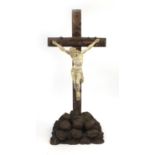Plaster Corpus Christi mounted on a wooden crucifix, 85cm high including the base