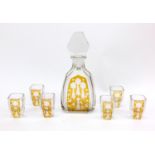 Art Deco amber flashed decanter and six shot glasses, engraved with stylised flowers, the decanter