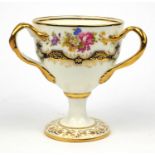 Cauldon porcelain three handled loving cup decorated with flowers, 17cm high Generally good