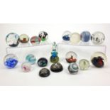 Group of colourful glass paperweights including Langham, Mdina and Caithness examples