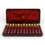 Set of twelve Russian silver gilt and enamel spoons, housed in original silk lined box, each 12cm