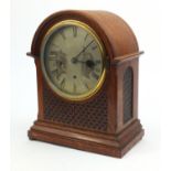 Oak cased dome topped Westminster chiming mantel clock with silvered dial and fretwork panels,