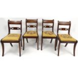 Set of four Regency mahogany dining chairs with needlepoint drop in seats