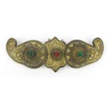 Middle Eastern gilt silver metal belt buckle set with red and green stones, 18cm diameter