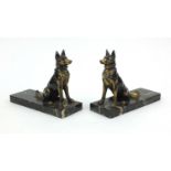Pair of Art Deco style book ends of dogs raised on marble bases, each 17cm high