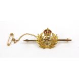 Military interest 15ct gold red enamelled bar brooch, 5cm diameter