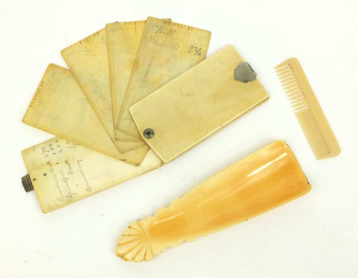 Ivory aide de memoire, ivory shoe horn and a child's comb, the largest 12cm long