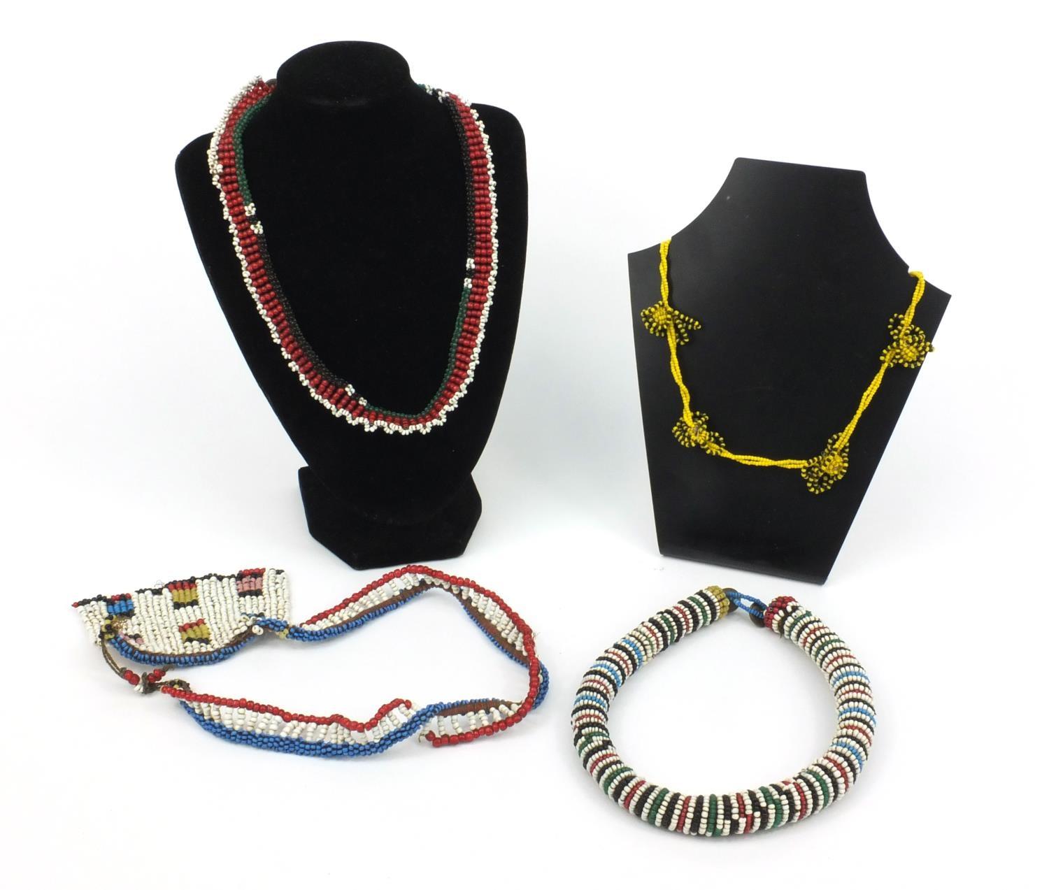 Four tribal beadwork necklaces, the largest 27cm long