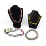 Four tribal beadwork necklaces, the largest 27cm long