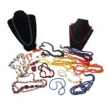 Selection of vintage costume jewellery necklaces including cherry amber coloured examples,