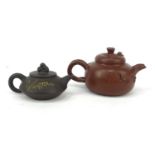 Two oriental Chinese Yixing pottery teapots, character marks to bases, the larger 8cm high The