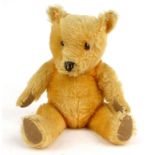 Straw filled teddy bear with beaded glass eyes, 57cm high