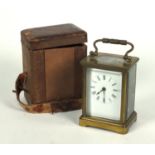 Brass carriage clock in a leather carrying case, 10cm high