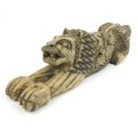 Carved Islamic hardstone figure of a stylised lion decorated with mythical creatures, 65cm long