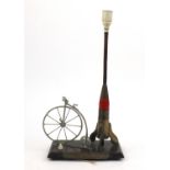 Military interest trench art table light titled 'Travel Through The Ages', raised on an oak base,