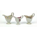 Three Newhall porcelain helmet shaped jugs hand painted with flowers and swags, the largest 13cm