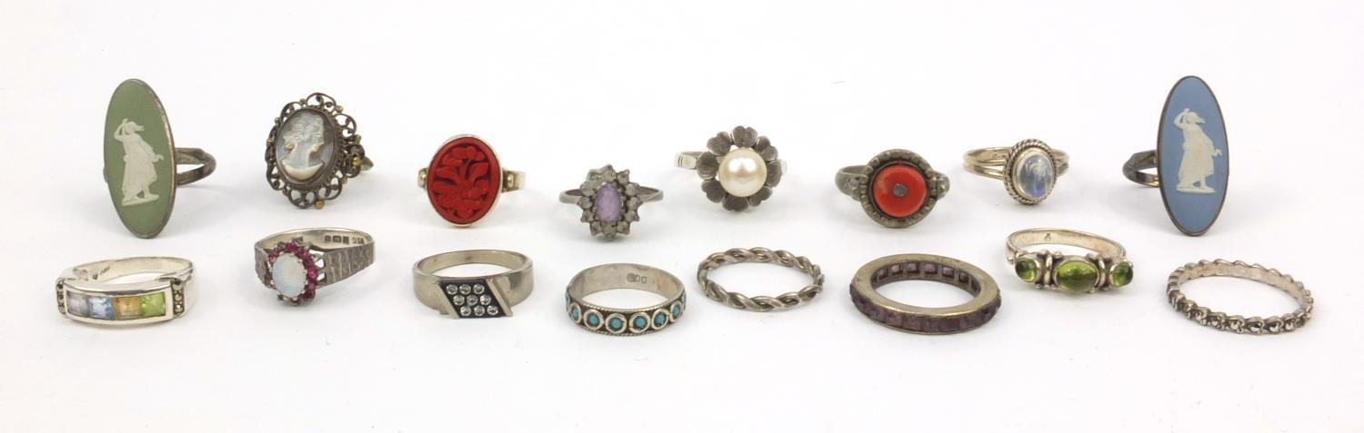 Collection of silver and white metal rings set with assorted stones, Wedgwood panels, etc,