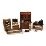 Collection of 1900's wooden and metal dolls' house furniture including dresser, cooker, wardrobe,