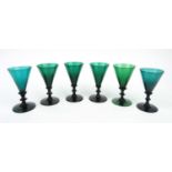 Six antique green glass wine glasses, each 13cm high