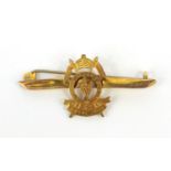 Military interest 9ct gold 5th Royal Irish pin badge, in a red silk box, 4.5cm long