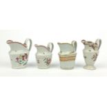 Four Newhall porcelain jugs hand painted with flowers and swags, the largest 12cm high The jug