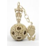 Oriental Chinese puzzle ball on chain carved with figures and fish, 25cm long