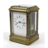 Brass repeating carriage clock with enamel dial, striking on a gong, 14cm high When wound the