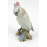 Royal Dux model of a parrot seated on a branch, with original paper label, 20cm high Generally