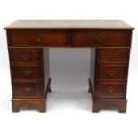 Mahogany twin pedestal desk with tooled leather top fitted with eight drawers, 79cm high x 106cm