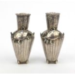 Pair of oriental Chinese silver basket shaped salts and peppers, character marks and 'SW' to the