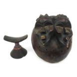 African tribal interest carved wooden beaded headrest and a large double faced mask, the larger 36cm