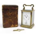 Victorian brass carriage clock striking on a gong, with original leather carrying case, 12cm high