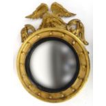 Regency gilt wood circular convex mirror with eagle crest