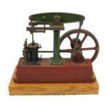 Stuart cast iron model of a beam engine, mounted on a wooden base, 33cm diameter