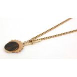 15ct gold watch chain with T-bar and large 9ct gold hardstone spinner fob, the chain 36cm long,