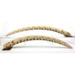 Large pair of ivory tusks carved with elephants, the longer 88cm long (PROVENANCE: Previously