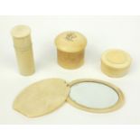 Three ivory screw top containers, together with an ivory hand mirror, the hand mirror 11cm long when