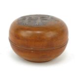 Oriental Chinese wooden bun shaped box carved with a gateway and landscape scene, 13cm diameter