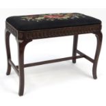 Carved oak stool with floral tapestry seat, 46cm high x 63cm long x 35cm deep