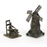 Unmarked Dutch silver windmill and miniature figure seated on a chair cooking, the windmill 9cm high